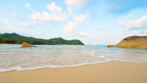 a sandy beach with rocks in the water at Panviman Resort Koh Phangan - SHA Extra Plus in Thong Nai Pan Noi