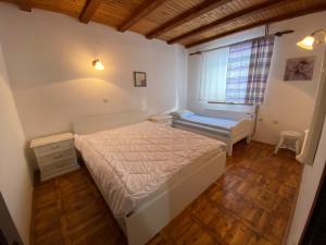 a small bedroom with a bed and a window at Vila Jela Tornik in Zlatibor