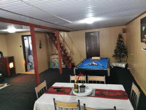 a room with a ping pong table and a christmas tree at Cabana lucia in Tarcău-Gheuca