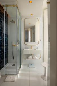 a bathroom with a shower and a sink and a mirror at Blue Liberdade Hotel in Lisbon