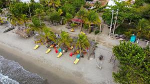 an aerial view of a beach with palm trees and a playground at Mar Amar Casa de Playa in Coveñas