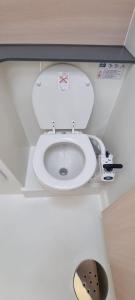 a bathroom with a white toilet in a room at Thea - MAGIC POINT in Mangalia +18 photos