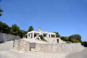 a house on top of a stone wall at Domus Valentina in Selva di Fasano