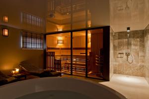 a bathroom with a shower and a bath tub at Palanga Visit Apartments and SPA in Palanga +79 photos