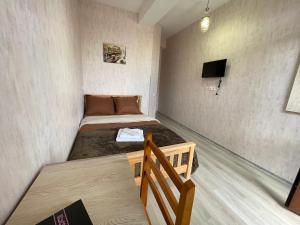 a small room with two beds and a television at Hotel Tradicia in Tbilisi City