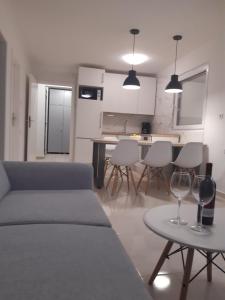 a living room with a couch and a table with wine glasses at Apartment Ivan in Vinišće