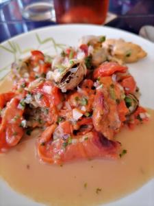 a white plate of food with shrimp and tomatoes at concon departamento in Concón +16 photos