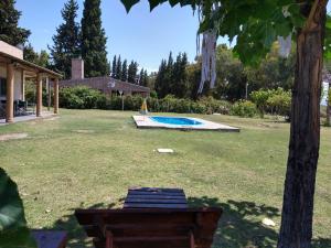 a swimming pool in a yard with a tree at Quinta Las Marías - Cabañas in San José de Jáchal +43 photos