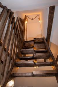 a wooden staircase in a room with lights at Cabana La Bica in Măgureni