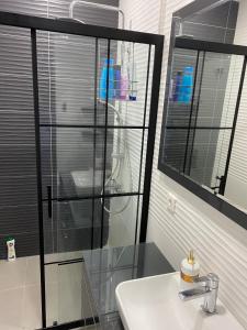 a bathroom with a glass shower and a sink at Villa Göcek in Göcek