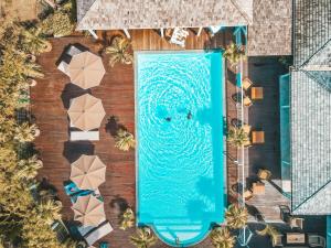 an overhead view of a swimming pool with a large blue screen at Hotel La Plantation in Orient Bay
