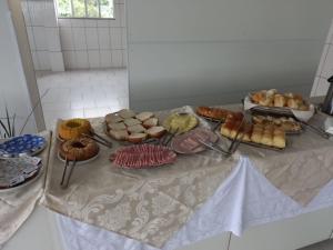 a table with many different types of pastries on it at Riachuelo Hotel in Resende