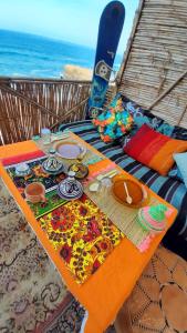 a picnic table with items on it on the beach at TAMRI BEACH HOUSE in Tamri