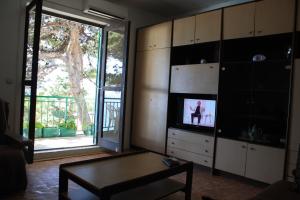 a living room with a tv and a table at Apartment Obnova Bager in Dugi Rat