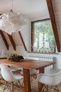 a dining room with a wooden table and chairs at Vista Mountain House in Kopaonik