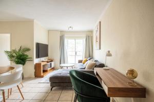 a living room with a couch and a table at Beautiful Two Bedroom Appartment In Hatfield in Pretoria