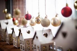 a row of christmas ornaments and houses are lined up at Vista Mountain House in Kopaonik