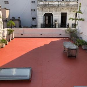a patio with a table and a building at HABITACION PRIVADA EN EDIFICIO HISTORICO in Buenos Aires +4 photos