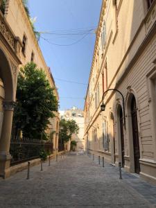 an empty street between two buildings in a city at HABITACION PRIVADA EN EDIFICIO HISTORICO in Buenos Aires