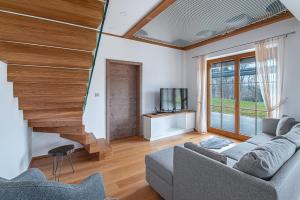 a living room with a couch and a television at Domačija Vrški in Slovenska Bistrica