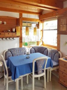 uma sala de jantar com uma mesa azul e cadeiras em Zentrale Ferienwohnung auf dem schönen Hunsrück em Halsenbach