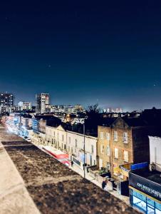 a view of a city at night at Duke and Duchess Apartments and Rooms - Private in Room Hot Tub Suites in London