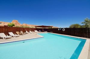 a swimming pool with chairs and a gazebo at On The Green #3378 in Moab