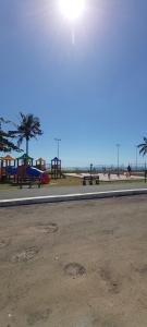 an empty park with a playground and a beach at apartamento para até 5 pessoas in Vila Velha