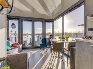 a kitchen and living room with a table and chairs at Modern Houseboat in Marina of Volendam with Swimming Pool in Volendam