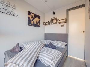 a bedroom with two beds and a clock on the wall at Modern Houseboat in Marina of Volendam in Volendam