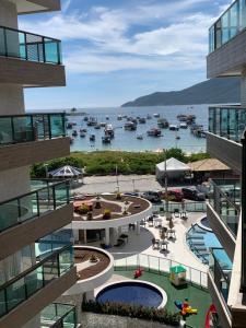 a view of a marina with boats in the water at apartamento de frente para o mar com linda area de lazer in Arraial do Cabo