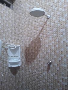 a bathroom with a shower with a shower head at Quarto bem próximo ao Pelourinho in Salvador +2 photos