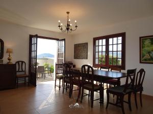 a dining room with a wooden table and chairs at LIMA COTTAGES - Casa de S Tiago in Ponte de Lima