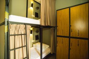a bedroom with two bunk beds and a mirror at Traveller Bunker Hostel 1 in Cameron Highlands