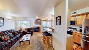 a kitchen and a living room with a couch and a table at Kayenta Springs #3243 in Moab