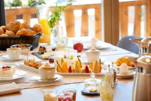 a table with breakfast foods and drinks on it at La Vue Luxury Living Apartments in Zermatt