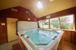 a large tub in the middle of a room at Pack Creek ~ Creekside East in Moab +6 photos