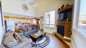 a large living room with a couch and a tv at Saddle Creek #3A1 in Moab