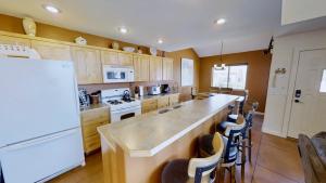 a kitchen with a counter and a white refrigerator at Saddle Creek #3A1 in Moab