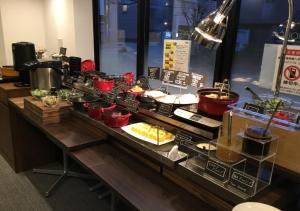 a buffet line with many different types of food at APA Hotel Shin Osaka Ekiminami in Osaka
