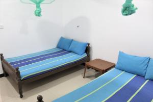 Ліжко або ліжка в номері The Sisara