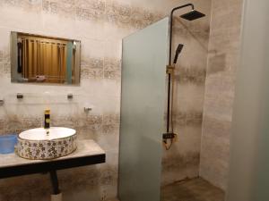 Woodridge Cottages Kalam في Kalām: حمام مع حوض ودش