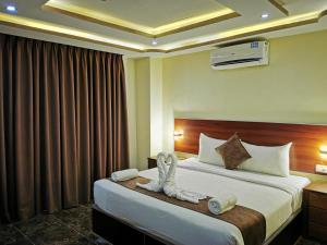 Una habitación de hotel con una cama con toallas. en TAJ Hotel en Áqaba