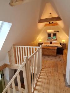 a attic bedroom with a bed and a staircase at Ferienhaus Landpause in Frohburg