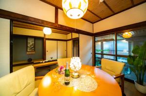a dining room with a table with a bottle of wine at Awaji Seaside Hotel in Ikuho in Awaji