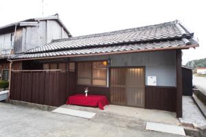 a small house with a red table in front of it at Awaji Seaside Hotel in Ikuho in Awaji