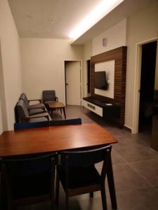a living room with a table and a couch at CAMERON TROPICA HOMESTAY in Cameron Highlands