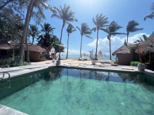 a swimming pool with a view of the ocean at Sea Love Beach Bar & Bungalows in Ban Tai