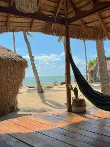 a hammock on a beach with the ocean at Sea Love Beach Bar & Bungalows in Ban Tai