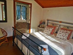 a bedroom with a bed and a window at Casa em Ponte de Lima in Ponte de Lima